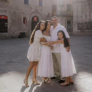 Family of four during a sunlit family photoshoot in Barcelona old town