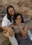 Emotional proposal reaction on stone steps in Barcelona, engagement ring visible