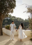 Couple walking hand in hand in Marimurtra Botanical Garden near Blanes with Mediterranean scenery