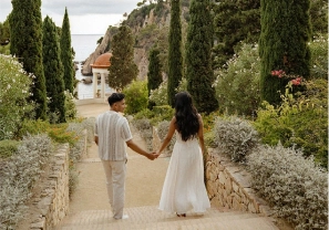 Romantic stroll through cypress-lined paths of Marimurtra Garden with sea view in the distance