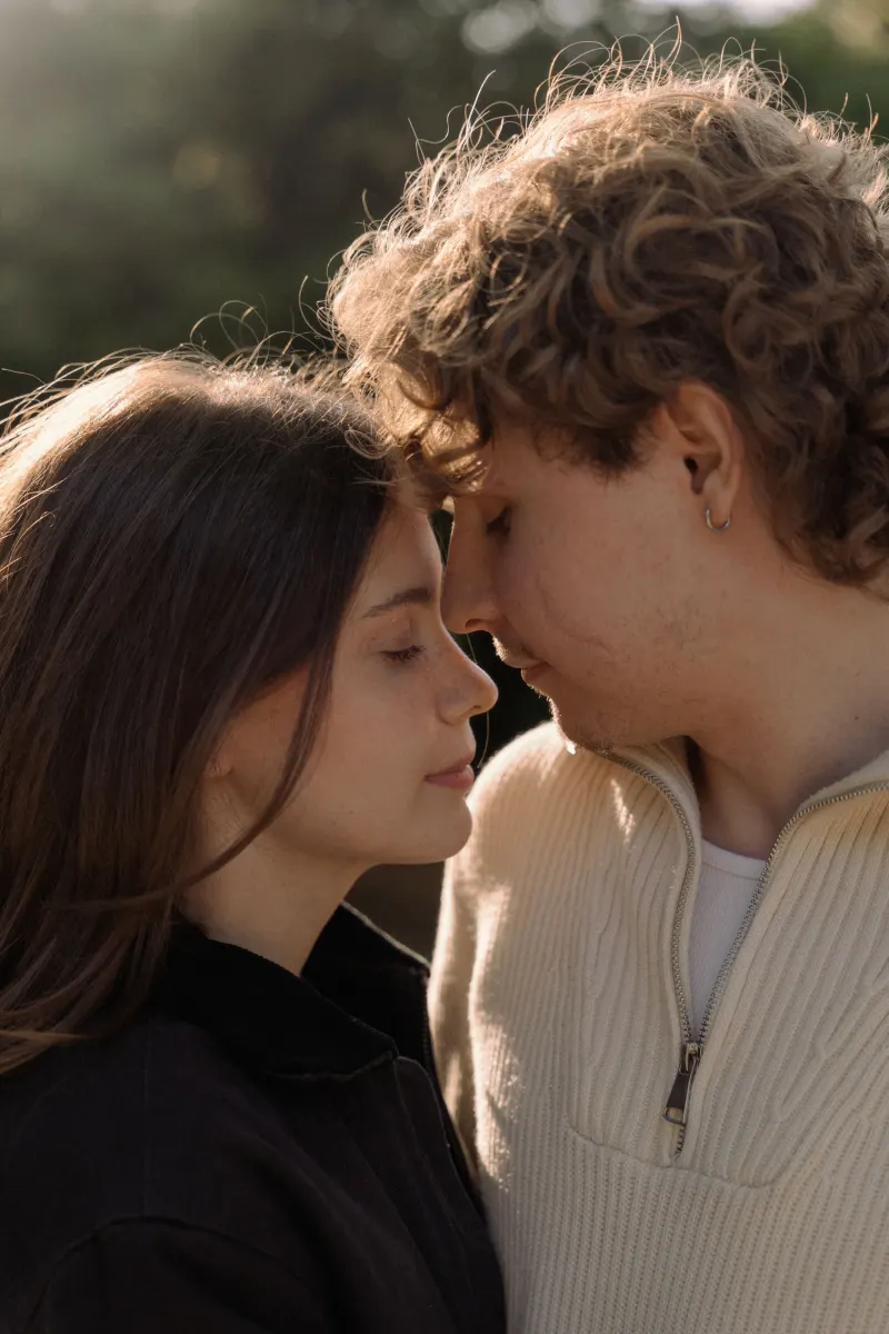 A couple shares a gentle, intimate moment at golden hour during a couples & engagements photoshoot in Barcelona.