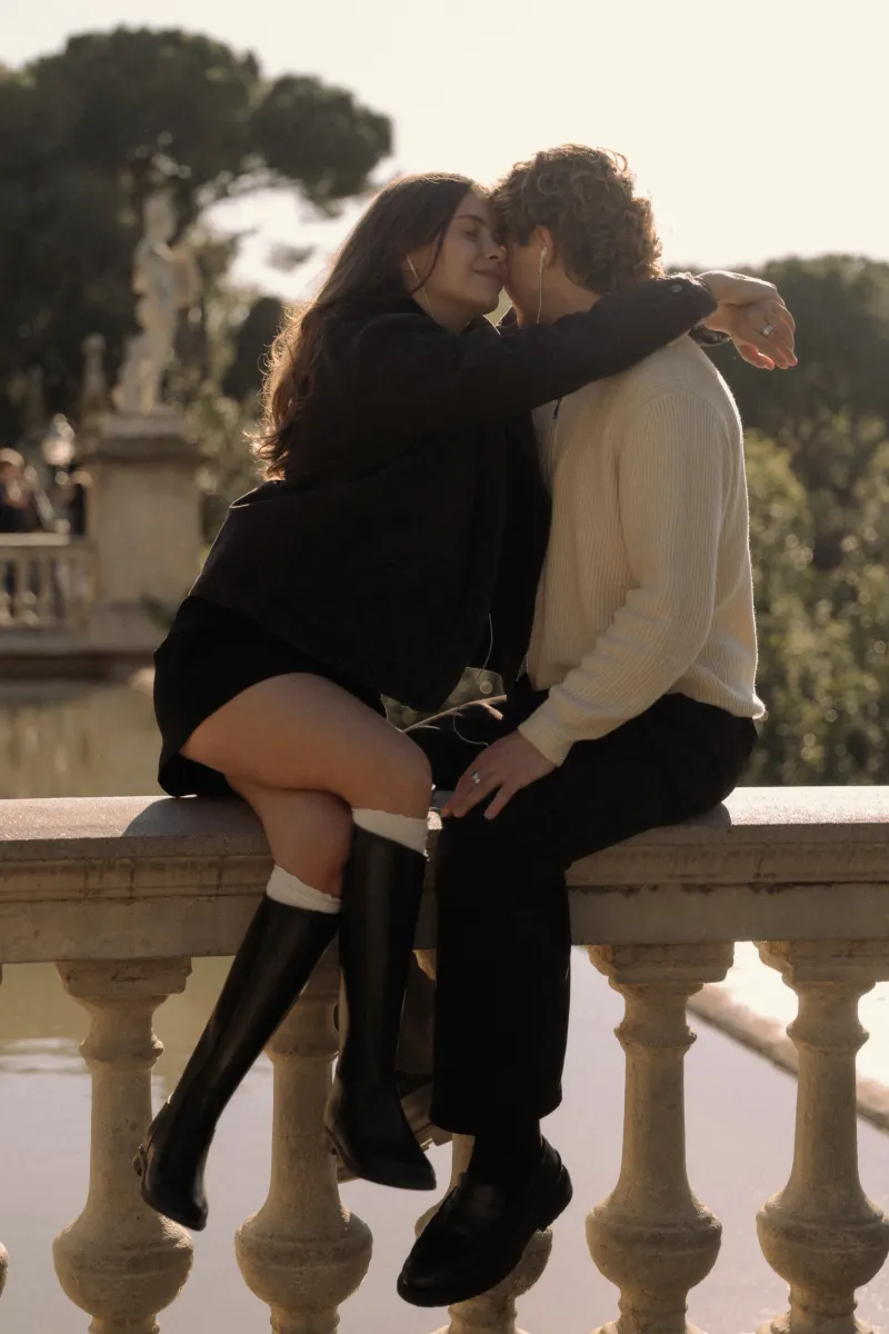 A couple shares a quiet embrace on a sunlit terrace in Barcelona, captured during a couples & engagements photoshoot.