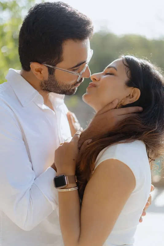 A couple shares a tender almost-kiss in soft sunlight during their surprise proposal photoshoot in Barcelona.