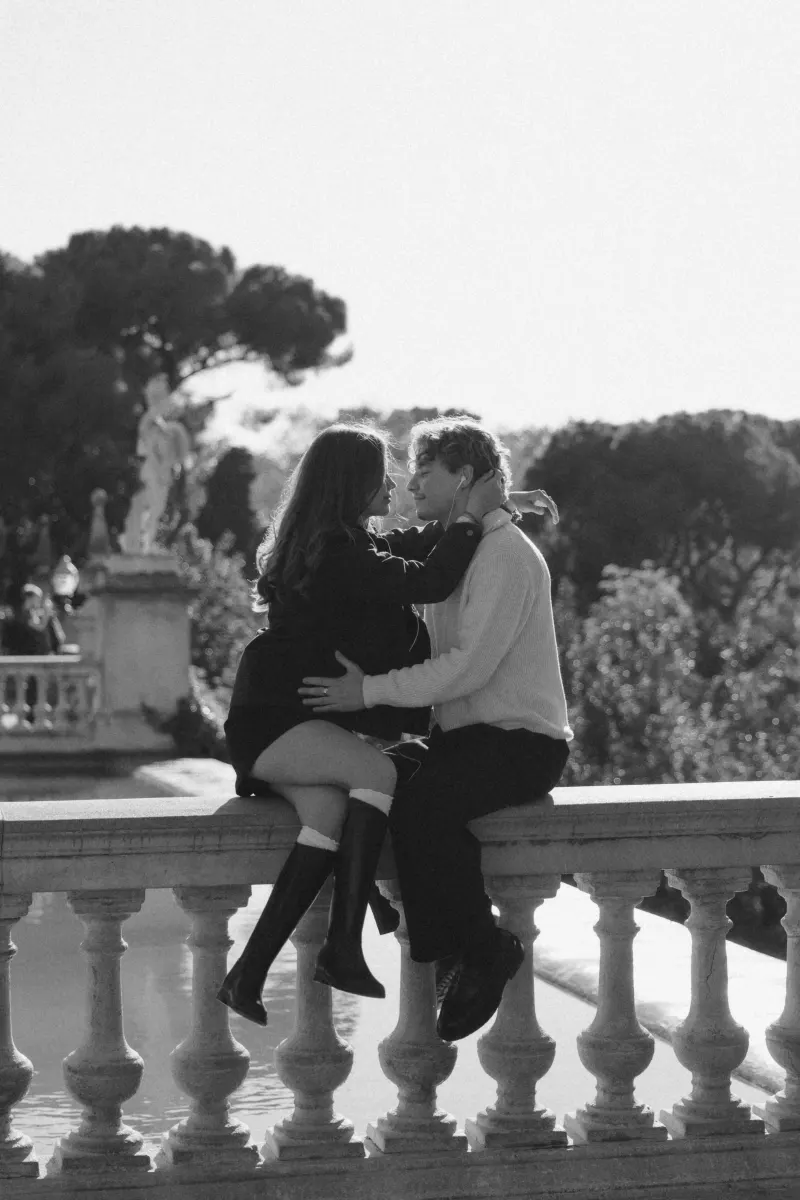 A couple shares music and a loving gaze on a sunlit terrace in Barcelona during a couples & engagements photoshoot.
