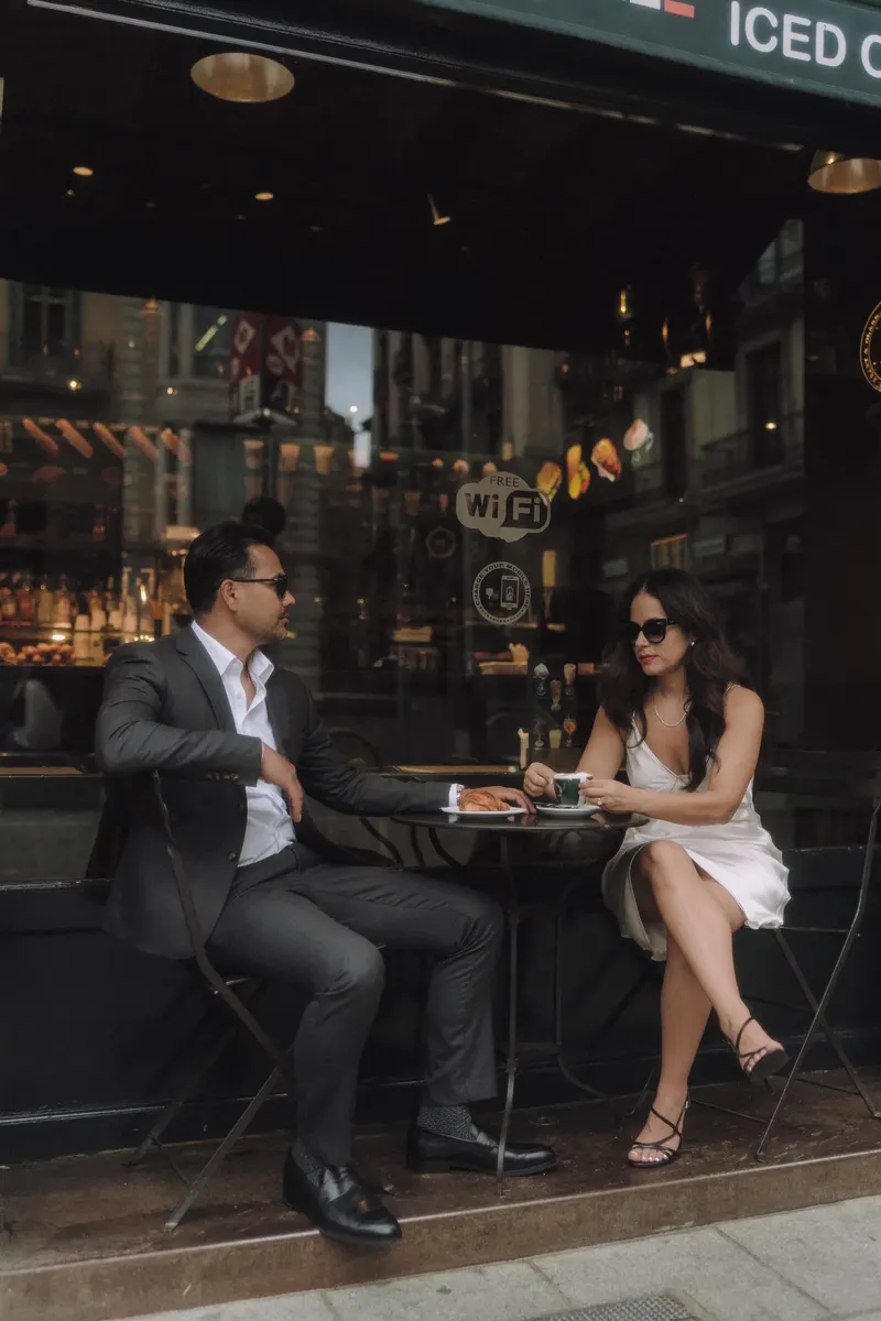 Ashley and Edgar enjoy coffee together at a street cafe in central Barcelona.