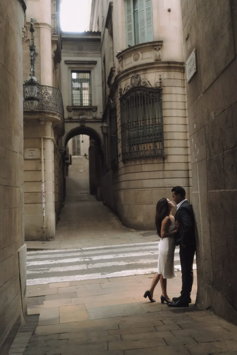 Ashley and Edgar share a close moment beside the stone arcades of the old city.