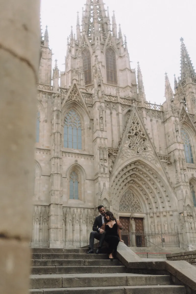 Ashley and Edgar sit beneath the spires of Barcelona Cathedral during a quiet morning photoshoot.