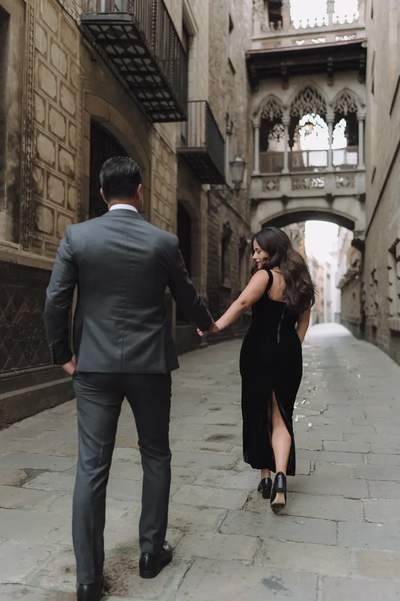 Ashley and Edgar walk hand in hand away from Pont del Bisbe on a quiet morning.