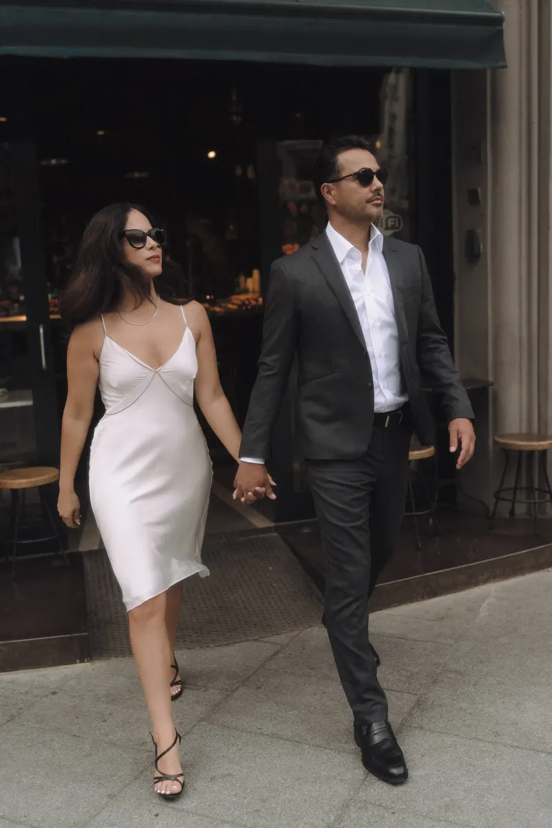 Ashley and Edgar walk onto the street after a coffee stop during their couple photoshoot.