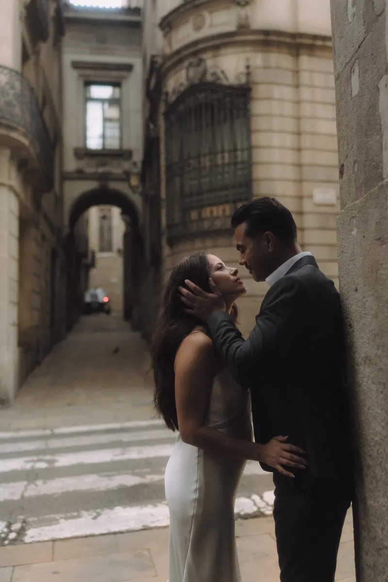 Ashley gently touches Edgar's face during an intimate portrait in the Gothic Quarter.