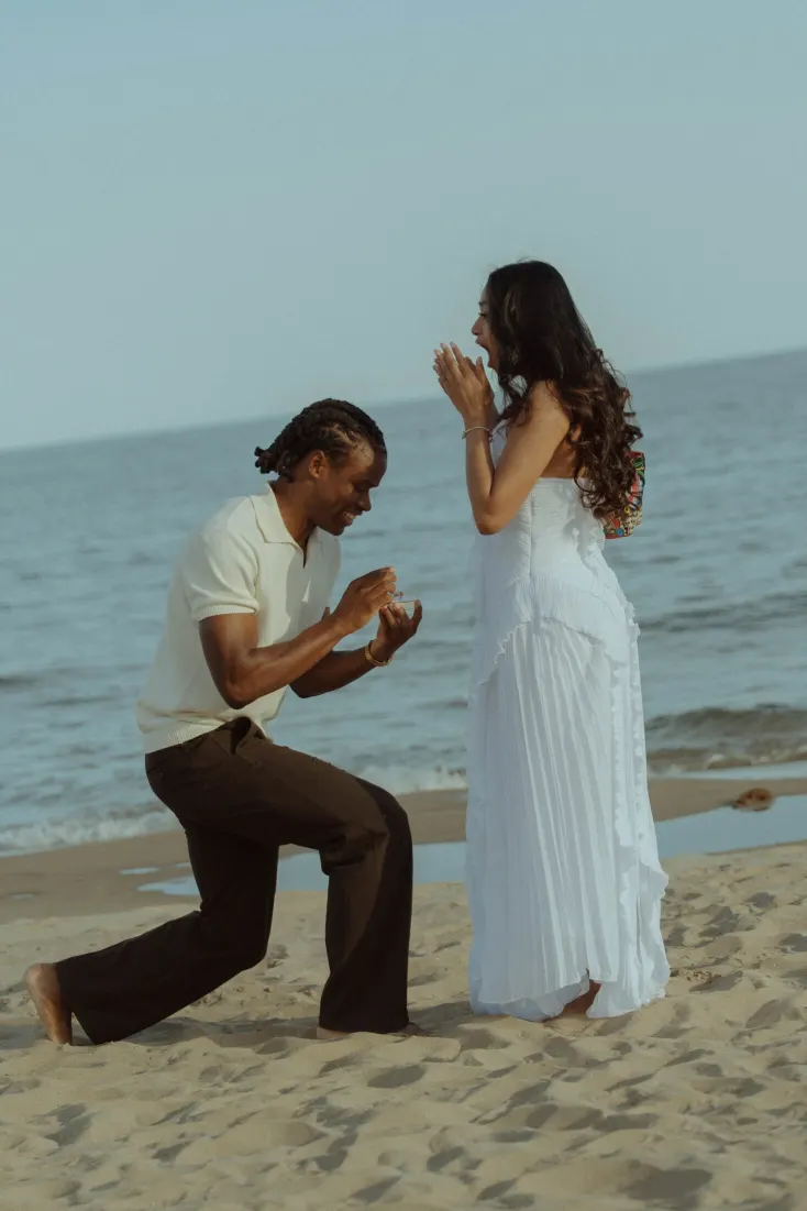 Cheryl covers her face in surprise as Dexter begins proposing on Castelldefels Beach near Barcelona.