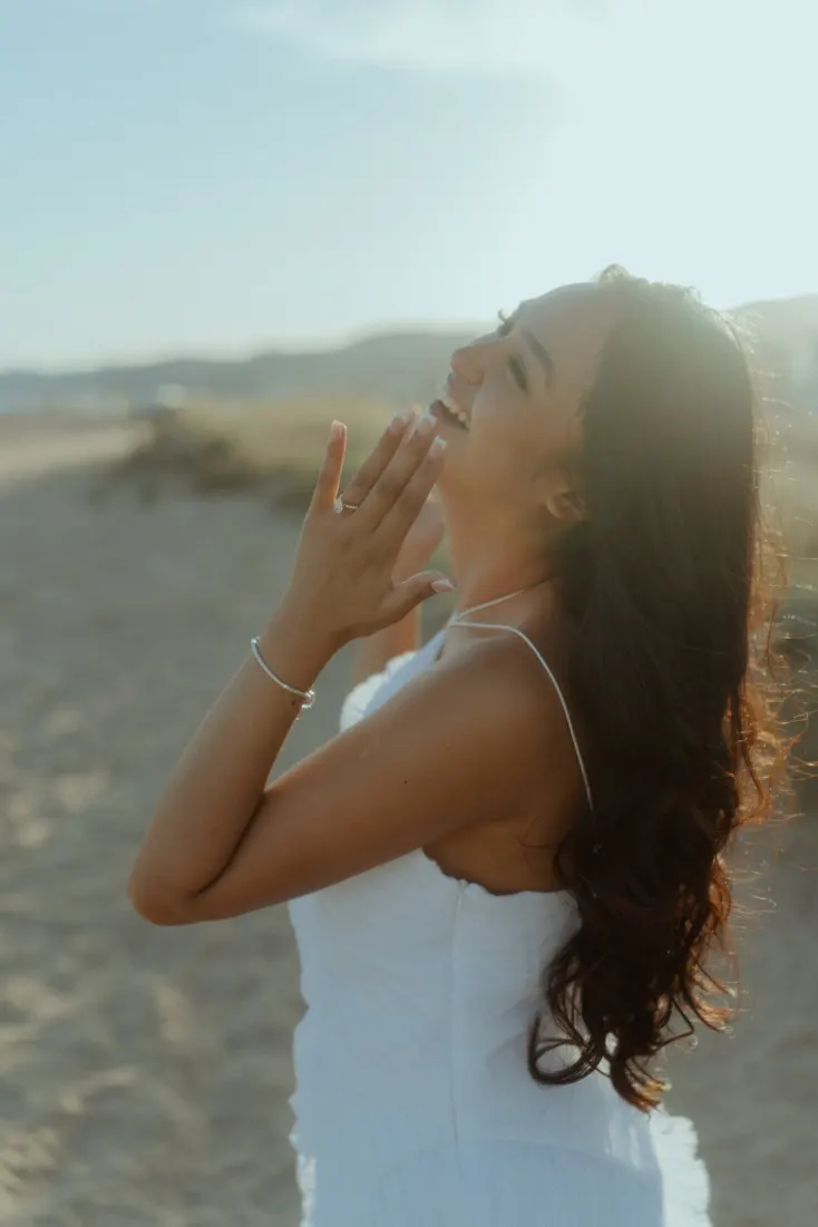 Cheryl shows her engagement ring during a golden-hour portrait session near Barcelona.
