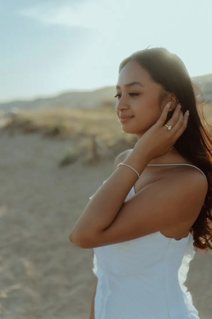 Cheryl smiles in warm evening light during her Castelldefels Beach engagement photoshoot.