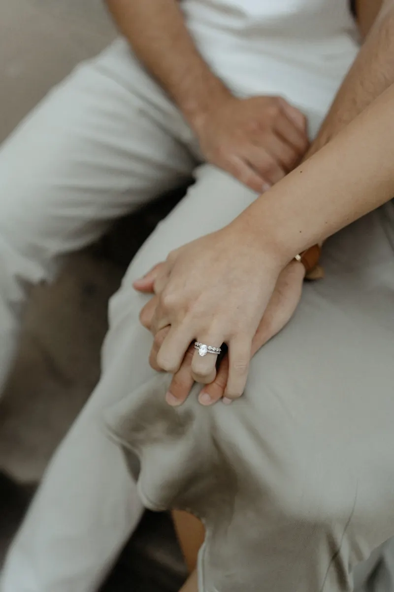 Close-up of a couple holding hands, engagement ring visible, captured during a Vacation Portraits session in Barcelona.