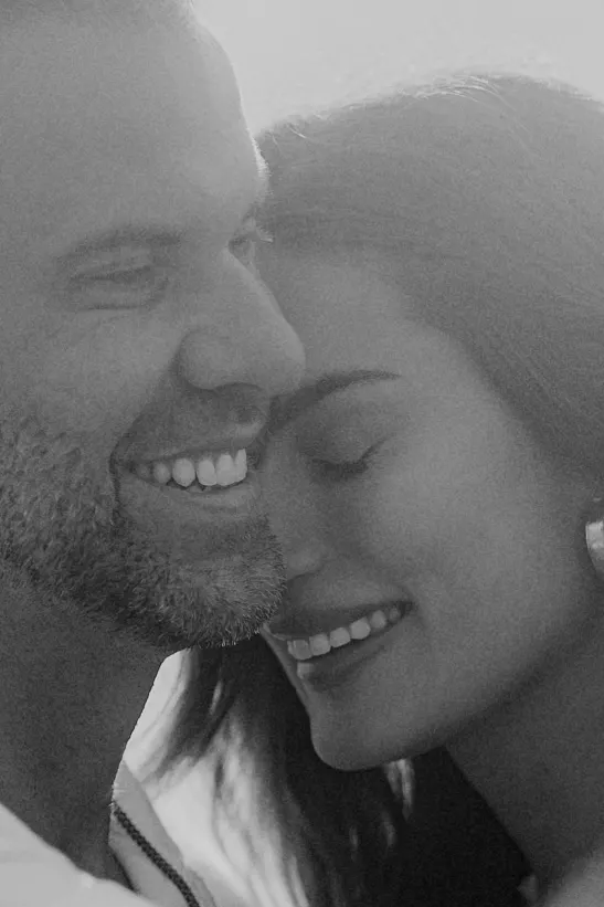 Close-up of a smiling couple sharing an intimate, joyful moment during a couples & engagements photoshoot.