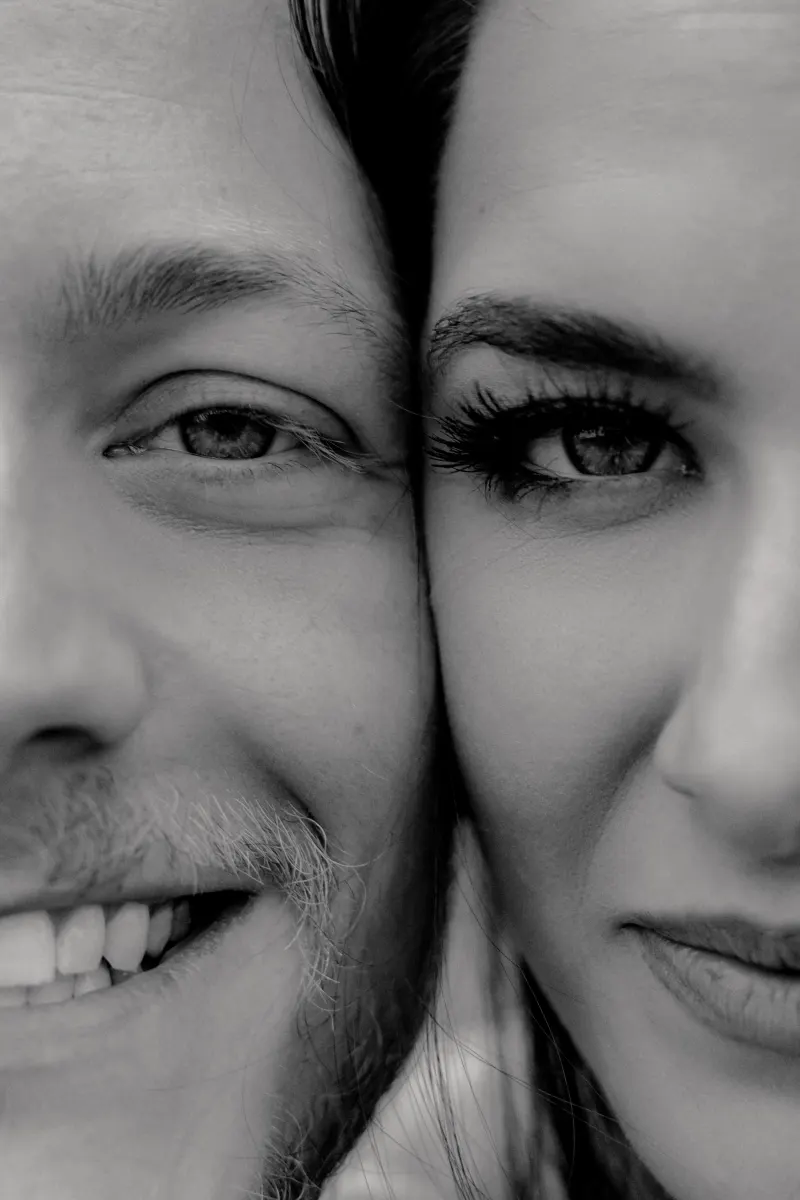 Close-up of a smiling couple’s faces, capturing love and excitement during a surprise proposal photoshoot.