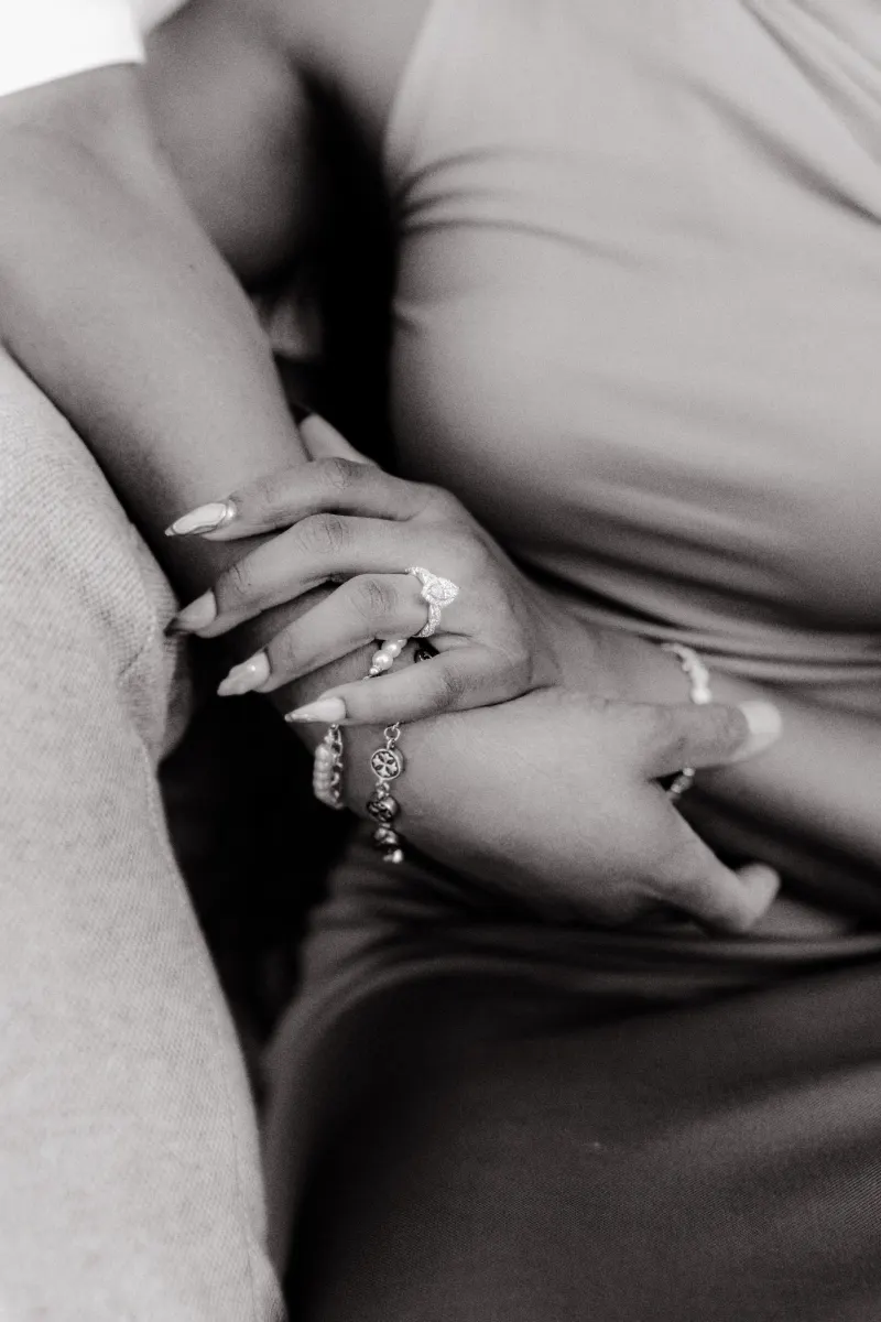 Close-up of intertwined hands, highlighting an engagement ring during a surprise proposal photoshoot in Barcelona.