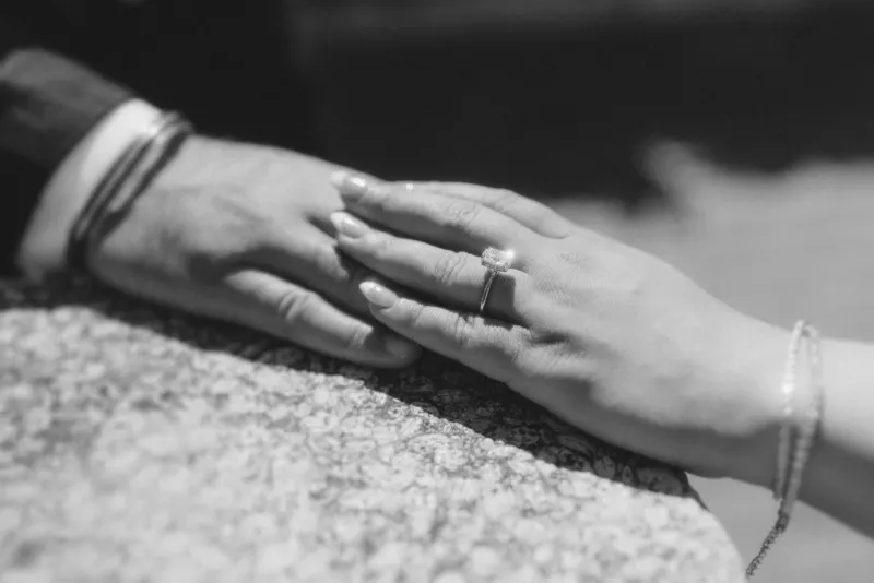 Close-up of joined hands in Begur, highlighting the engagement ring during a surprise proposal photoshoot.
