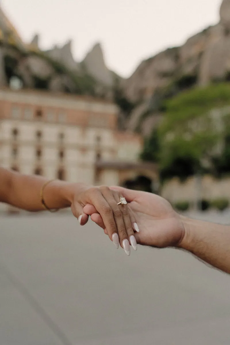 Close-up of Sydney’s hand and engagement ring held by Dan in Montserrat.
