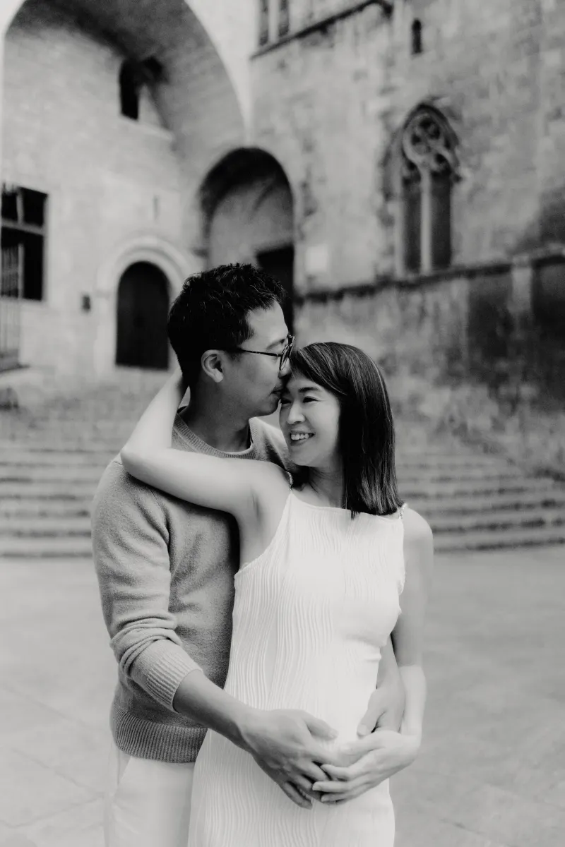 Couple embraces and smiles during a Vacation Portraits photoshoot in Barcelona’s historic city center.