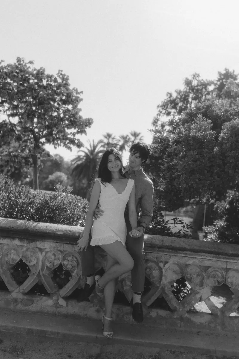 Couple enjoying a tender moment together on a sunlit garden terrace during a couples & engagements photoshoot.