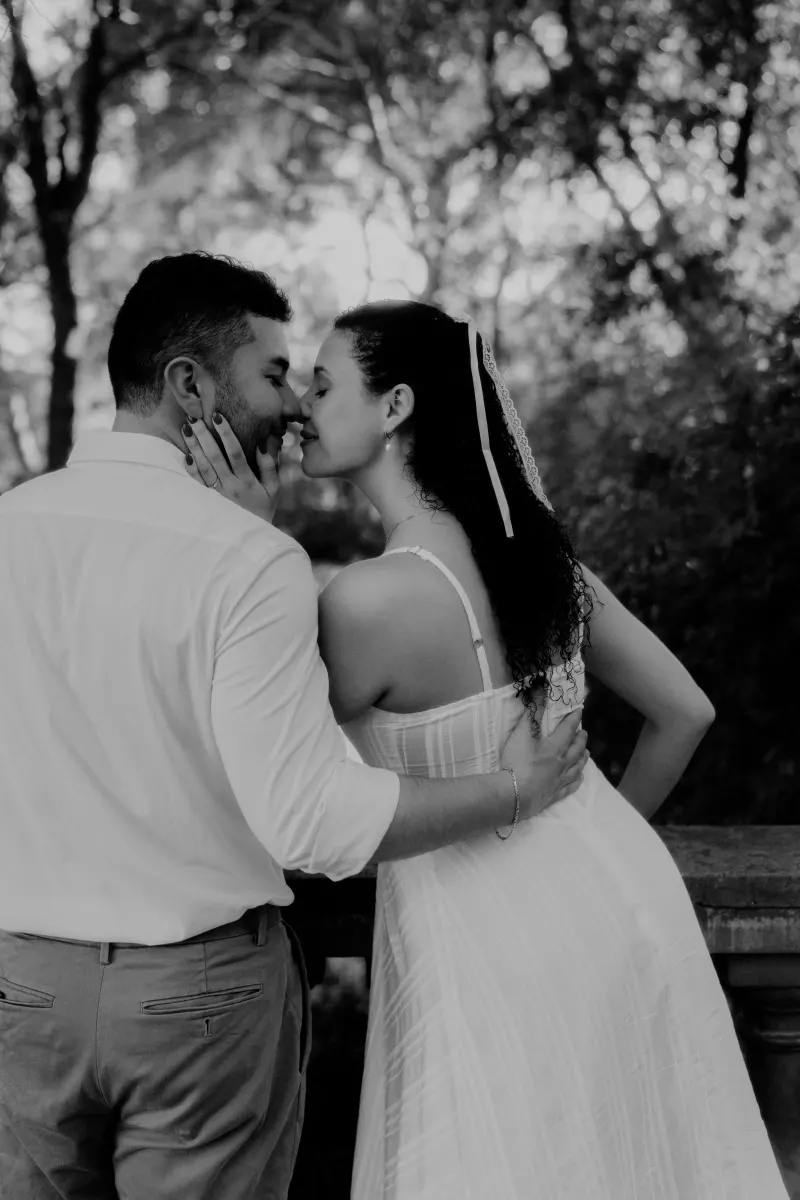 Couple shares a gentle nose-to-nose moment on a garden terrace during a couples & engagements photoshoot.