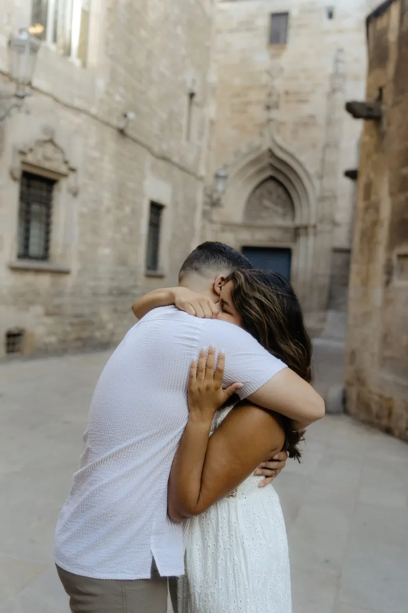Couple shares a heartfelt embrace in a quiet historic alley during their couples & engagements photoshoot.