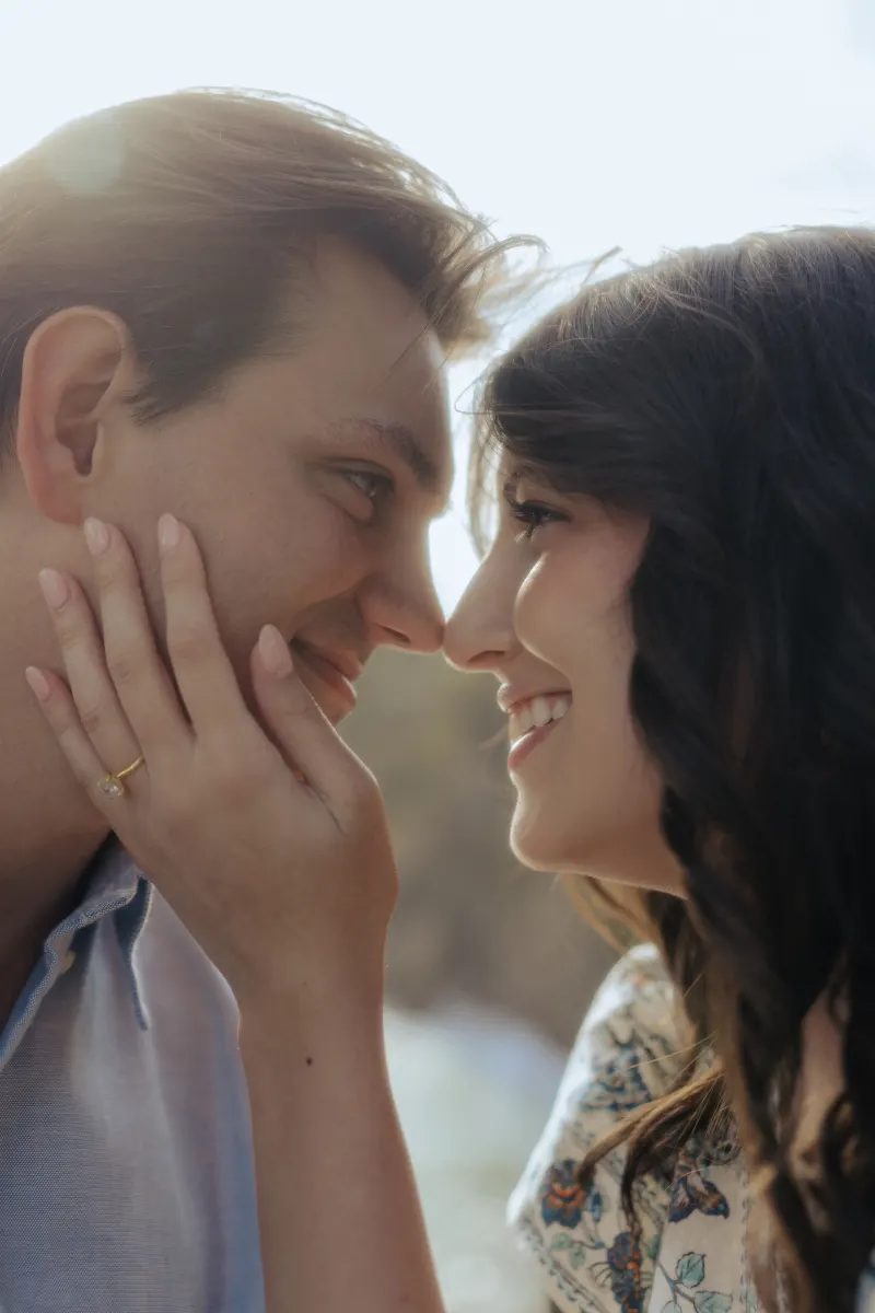 Couple shares a joyful, intimate moment after saying yes during a Mediterranean surprise proposal photoshoot.