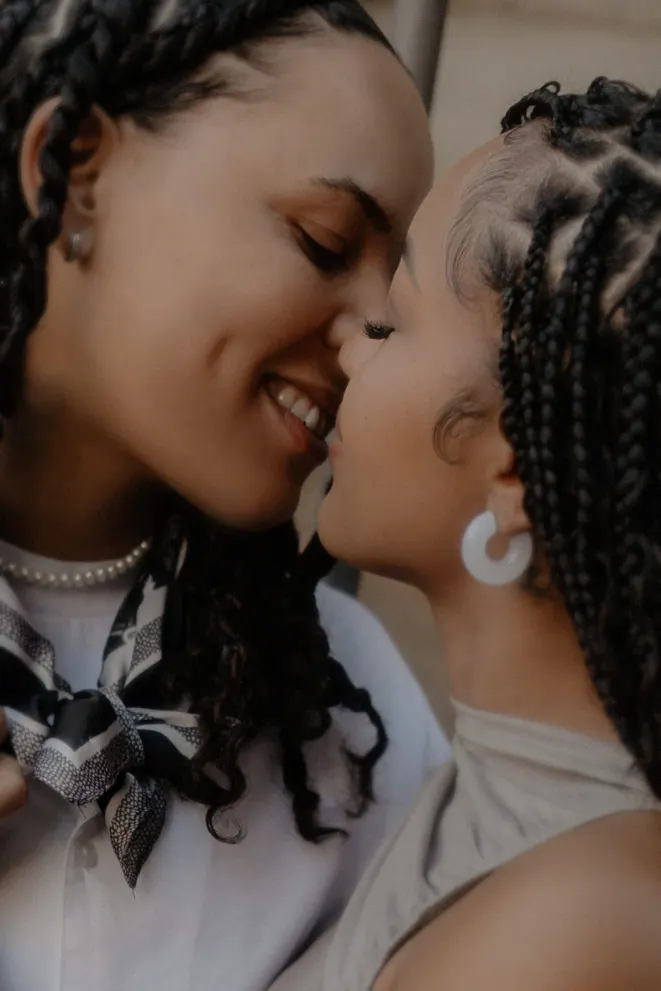 Couple shares a joyful, intimate moment just before a kiss during their surprise proposal photoshoot in Barcelona.