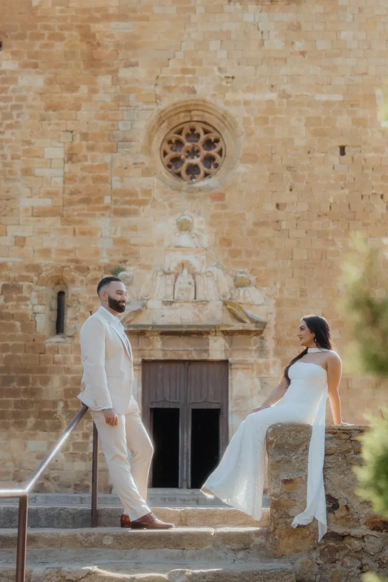 Couple shares a joyful moment on historic stone steps after a surprise proposal, captured during a romantic photoshoot.