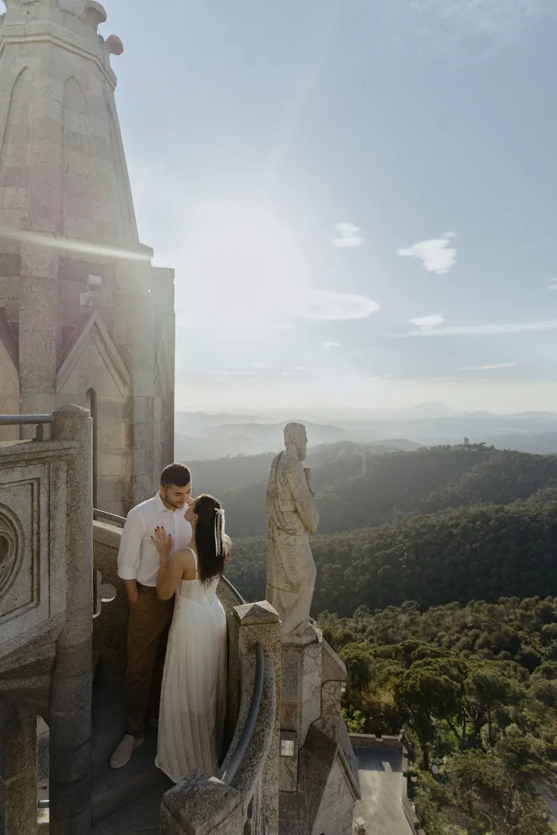Couple shares a tender moment on a castle staircase at sunset, captured during a romantic couples & engagements photoshoot.