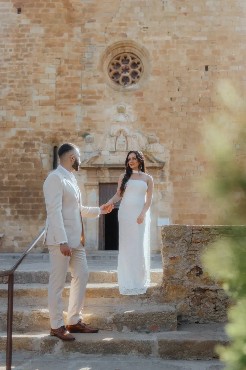 Couple shares a tender moment on ancient stone steps after a surprise proposal, captured during a romantic photoshoot.