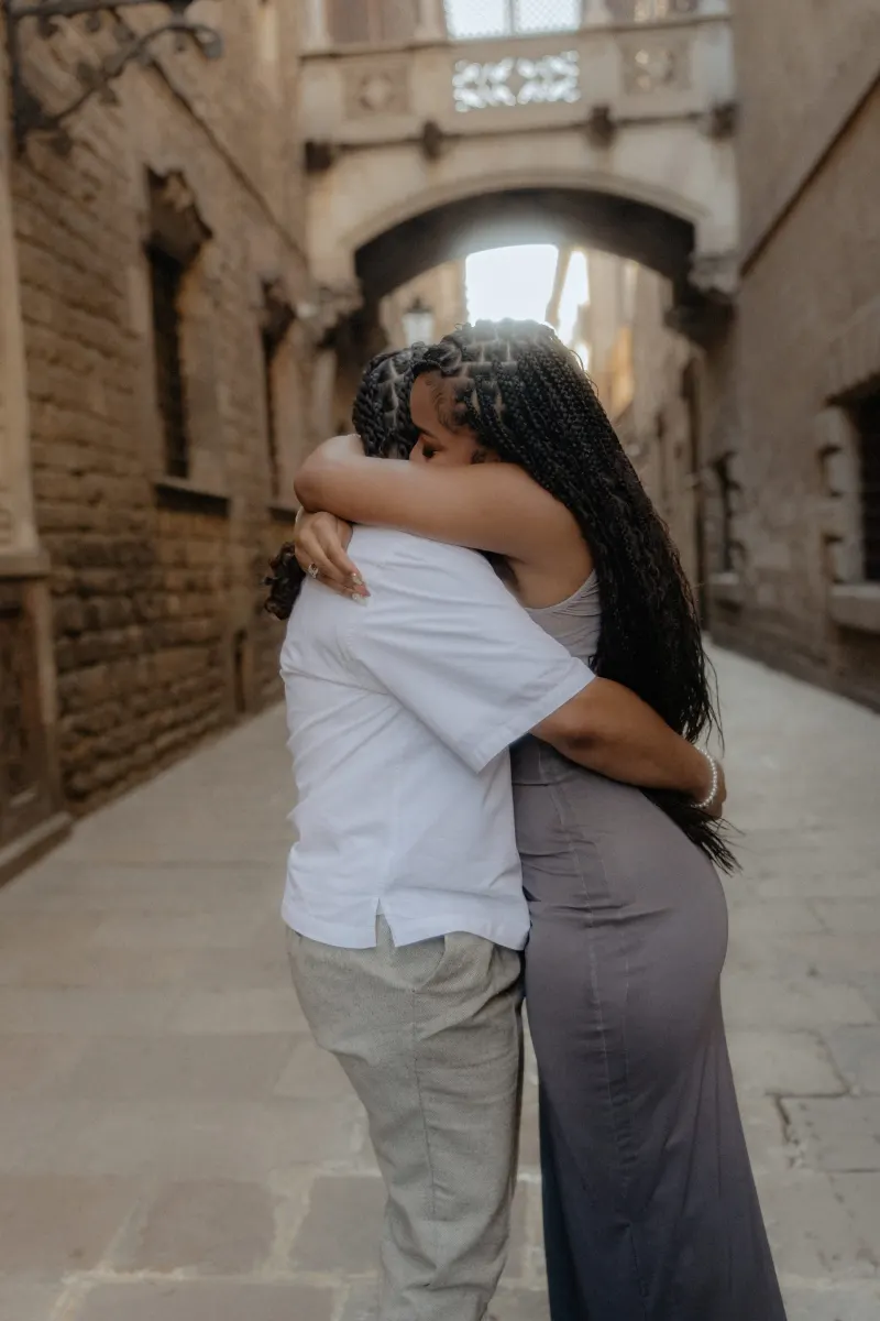 Couple shares an emotional embrace in Barcelona’s Gothic Quarter after a surprise proposal photoshoot moment.