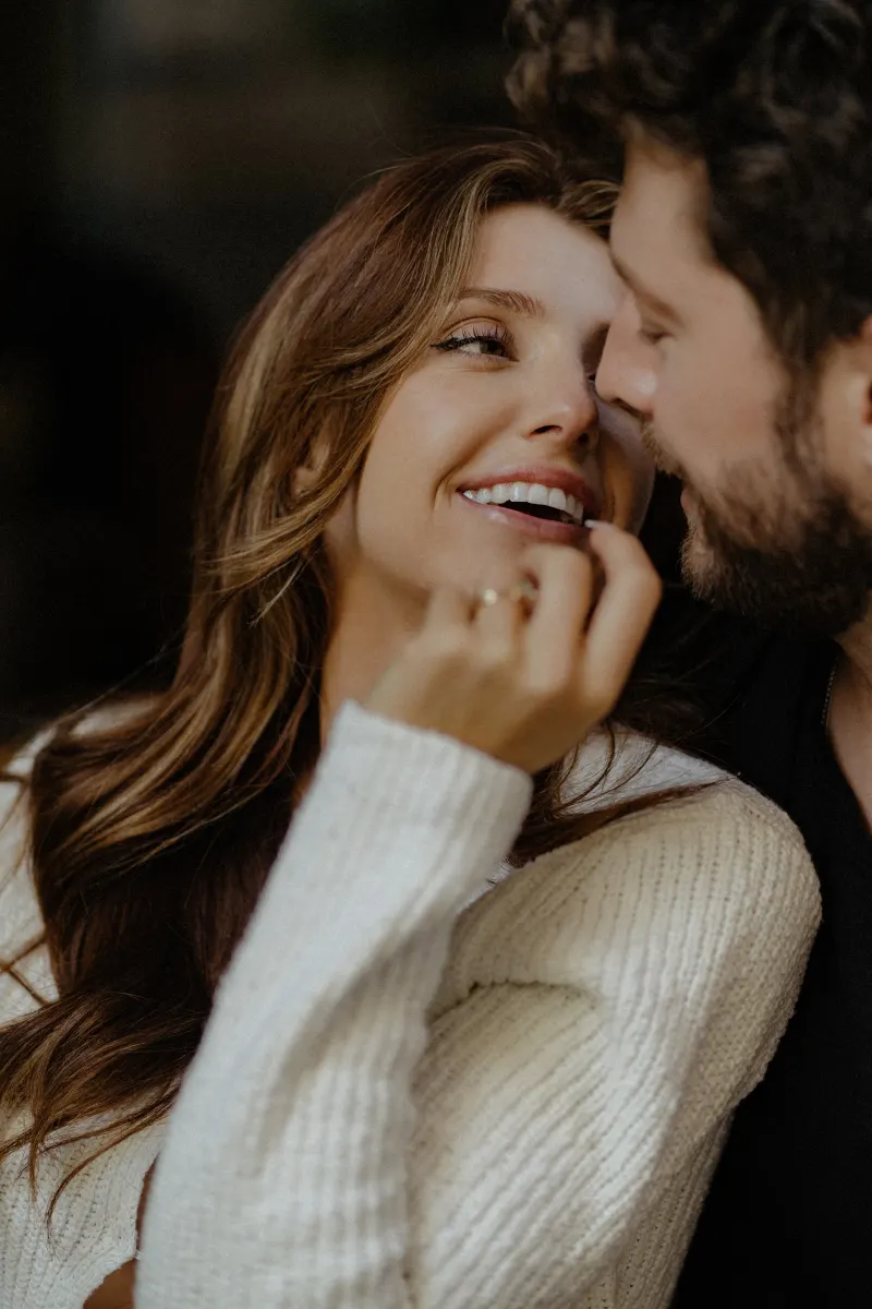 Couple shares an intimate, joyful gaze during a couples & engagements photoshoot, highlighting their connection.