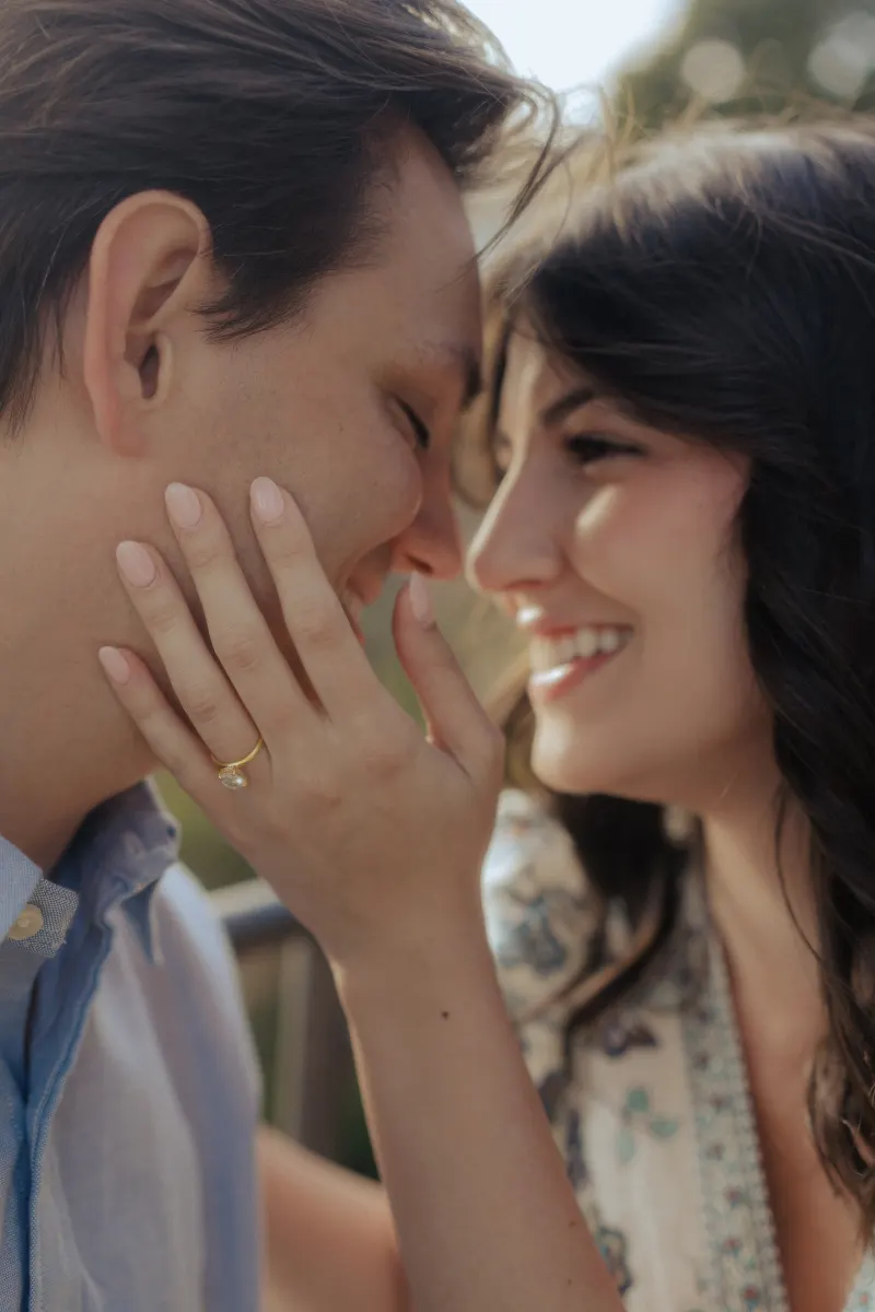 Couple shares an intimate, joyful moment as she shows off her engagement ring during a surprise proposal photoshoot.
