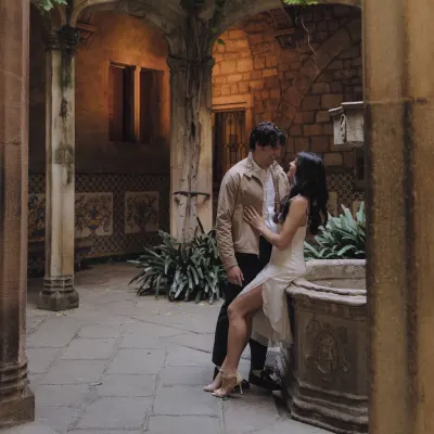 Couple shares an intimate moment in a historic courtyard, perfect for a romantic engagement photoshoot session.