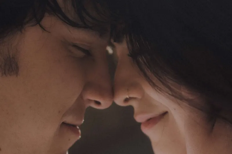 Couple sharing a gentle, intimate forehead touch and soft smiles during a couples & engagements photoshoot.
