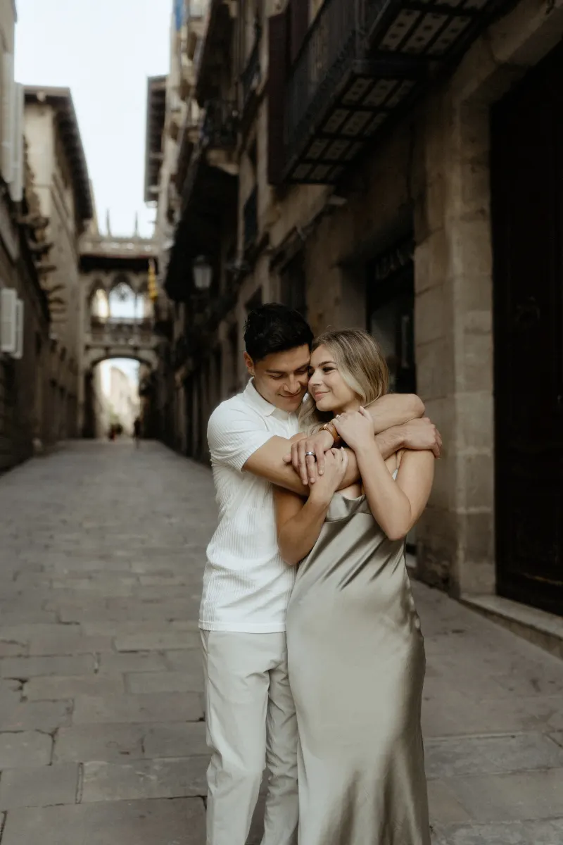 Couple sharing a loving embrace on a quiet street in Barcelona’s Gothic Quarter during a Vacation Portraits photoshoot.