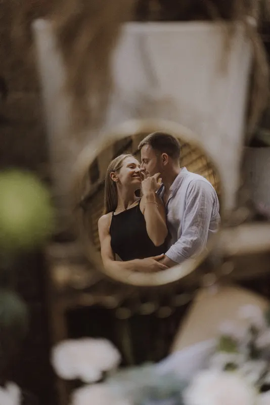 Couple sharing a loving, intimate moment reflected in a mirror during a couples & engagements photoshoot.