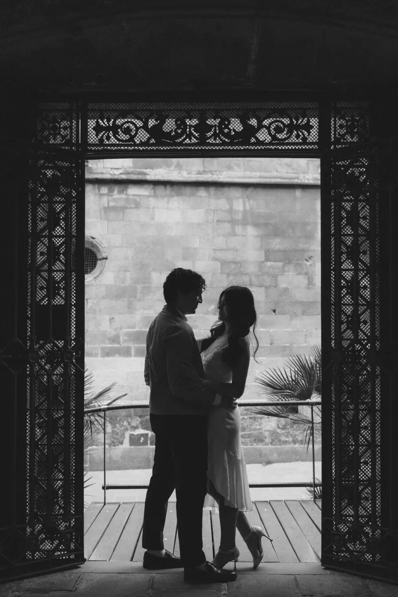 Couple sharing a quiet, intimate moment in a historic archway during a couples & engagements photoshoot.