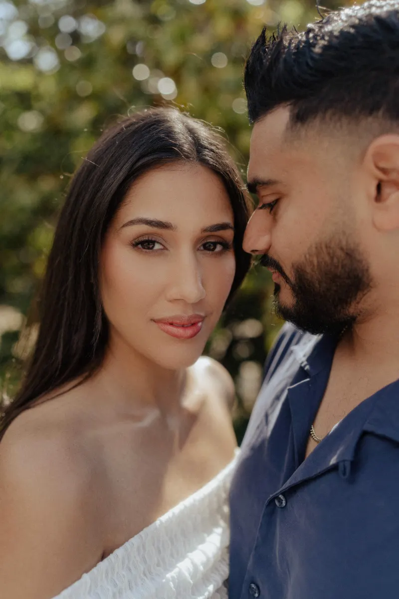 Couple sharing a quiet, intimate moment outdoors, captured during a couples & engagements photoshoot in soft natural light.