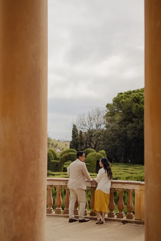 Couple sharing a quiet moment together on a garden terrace, captured during a couples & engagements photoshoot.