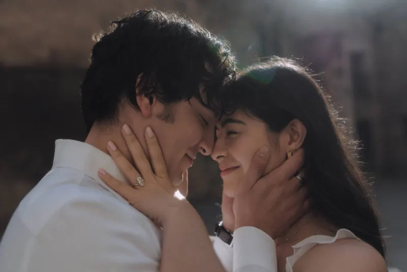 Couple sharing a soft, intimate forehead touch and gentle smiles during a couples & engagements photoshoot in natural light.