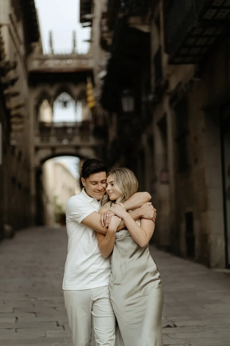 Couple sharing a warm embrace in Barcelona’s Gothic Quarter during a Vacation Portraits photoshoot.
