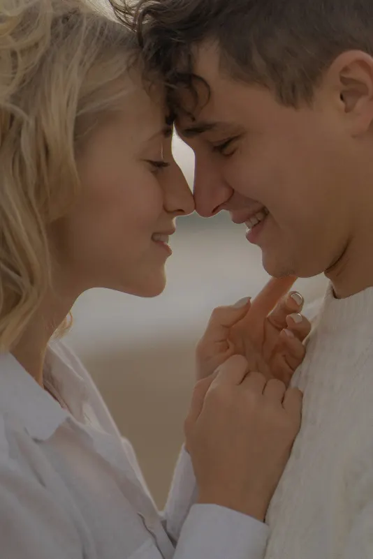 Couple smiles softly with foreheads touching, sharing a close moment during a couples & engagements shoot in Barcelona.