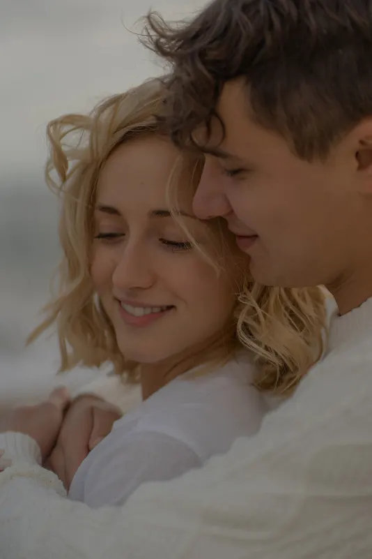 Couple wrapped in a cozy embrace, sharing a peaceful moment during a couples & engagements photoshoot in Barcelona.