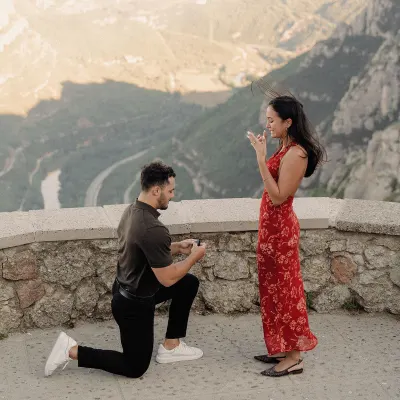 Dan and Sydney beneath a monumental stone arch in Montserrat after their surprise proposal.