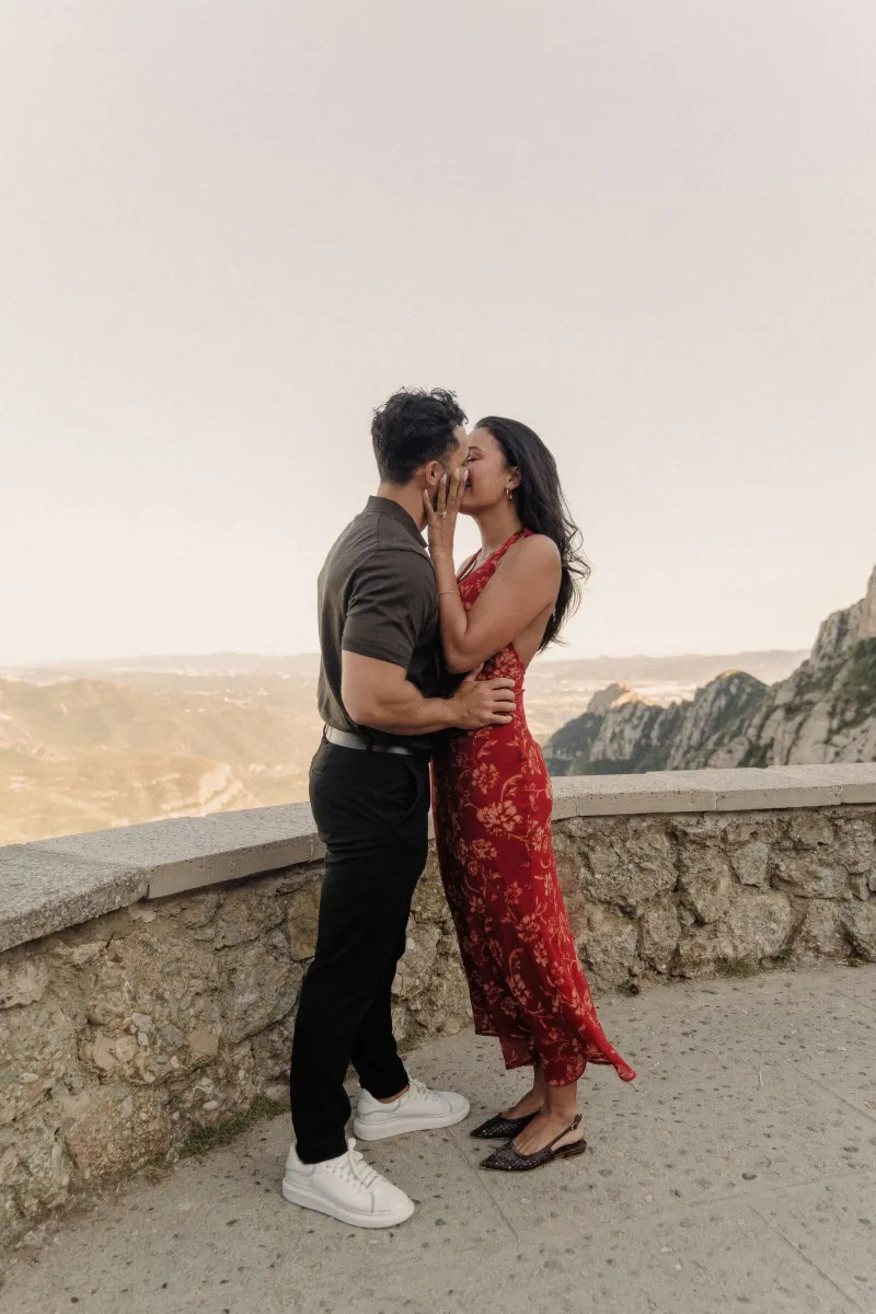 Dan and Sydney kiss beside the viewpoint wall after their surprise proposal in Montserrat.