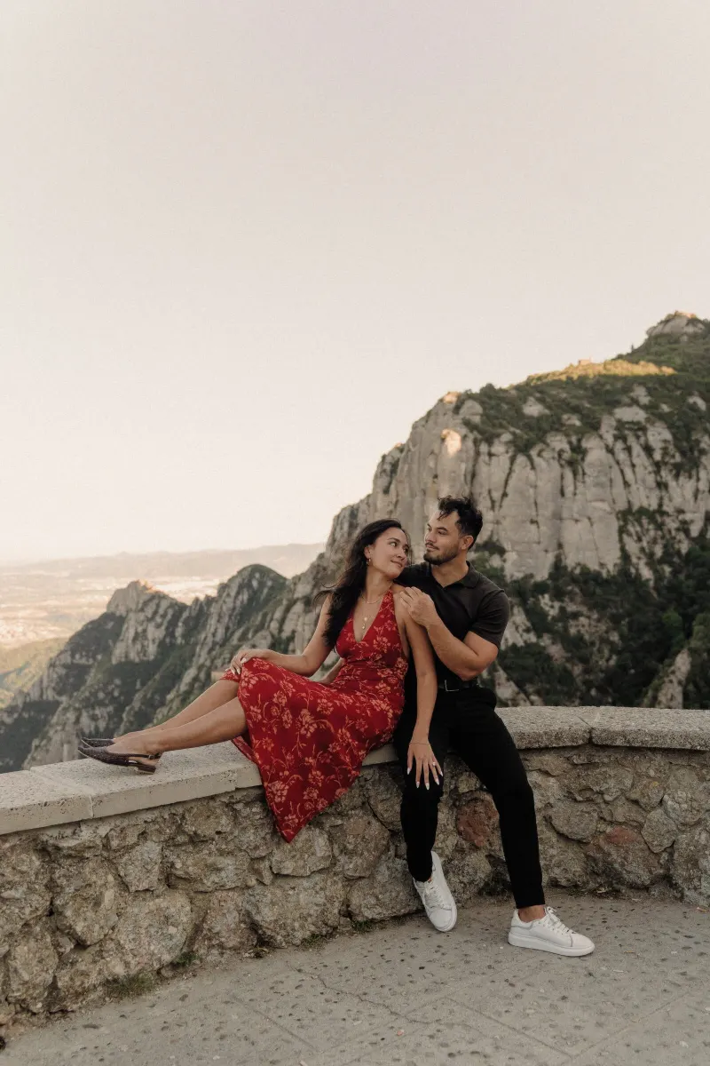 Dan and Sydney laugh together on the viewpoint wall after becoming engaged in Montserrat.