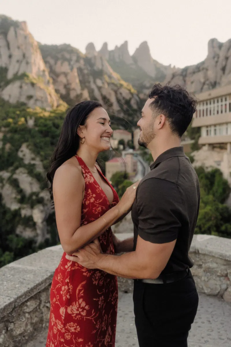Dan and Sydney share a close portrait with the monastery and mountain peaks behind them.